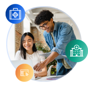 Two international students work together at a laptop in a sunny library space.