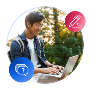 A male international student sits with an open laptop on campus at sunset or sunrise.