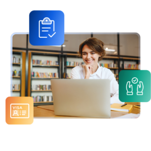 International student smiling at a laptop in a library