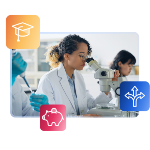 An international students looks into a microscope at a specimen in a lab